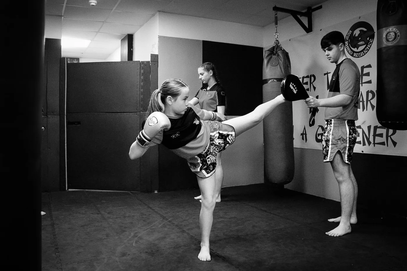 Young student practising kickboxing in a class