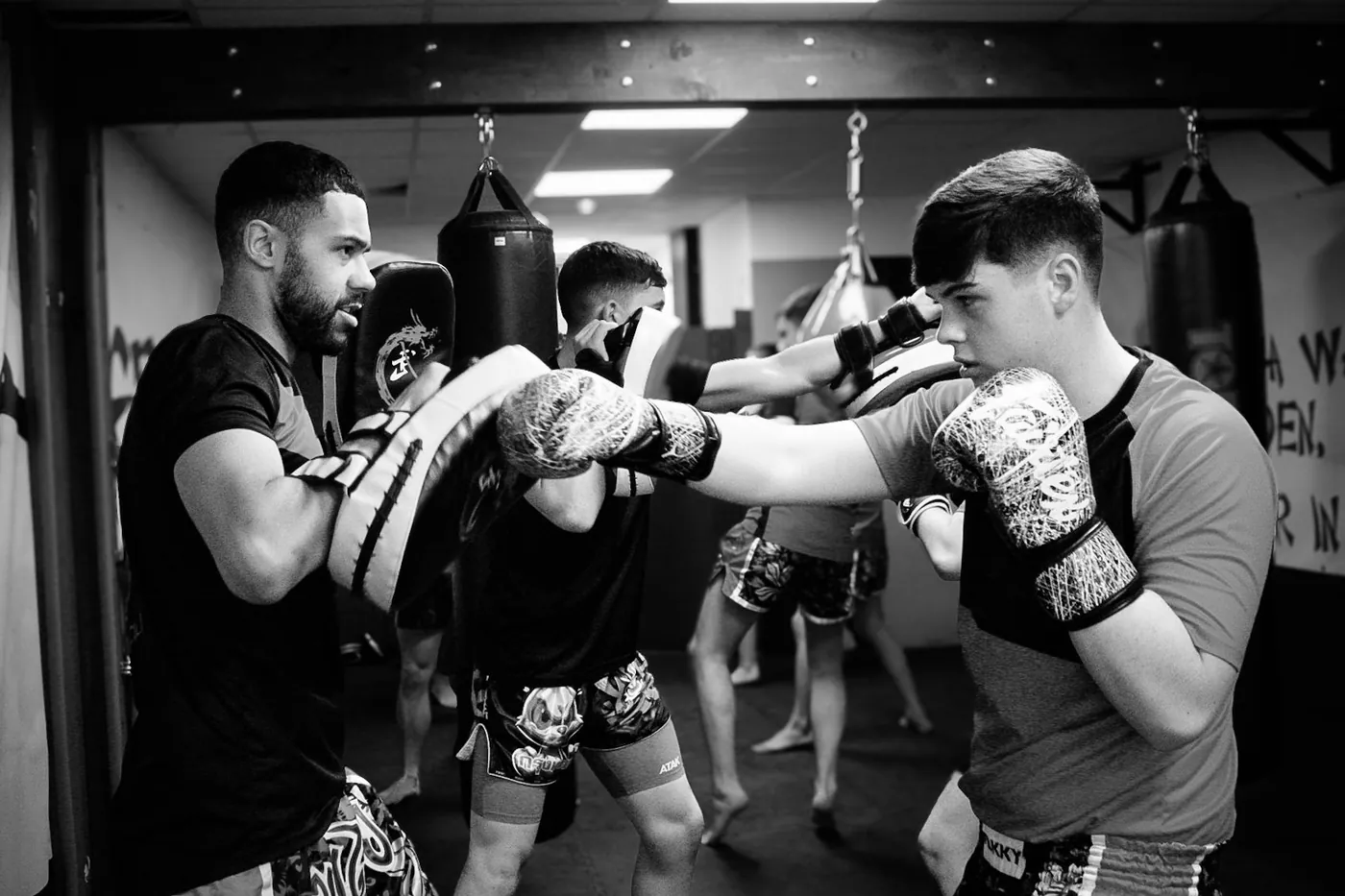 Adults and teens training together in a kickboxing class