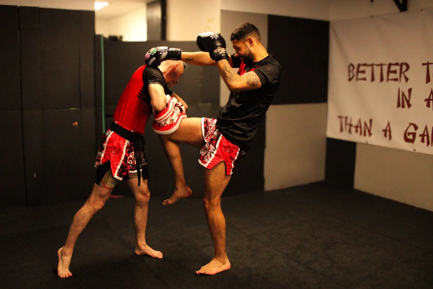 Adults practising K1 kickboxing drills